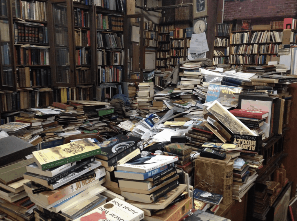 unorganized library with a mess of books in center 